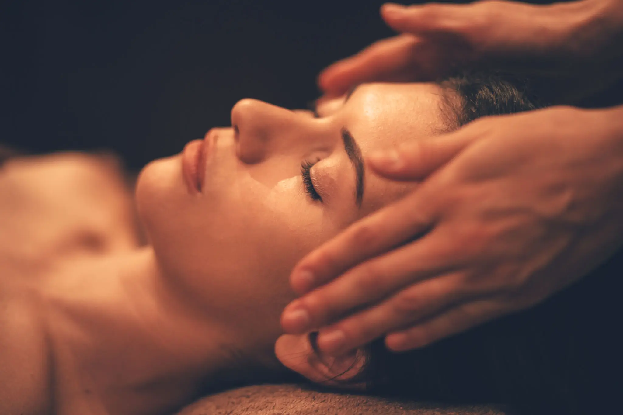 Hands gently massaging face